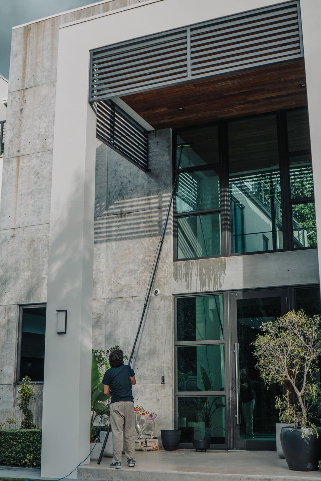 Coast technician cleaning the exterior glass of a multi-story building in Miami